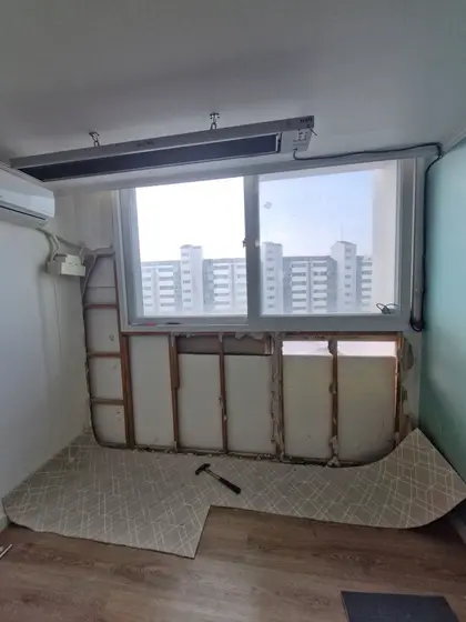 기존 석고보드와 스티로폼을 철거하고 목재 틀만 남긴 창 아래 벽